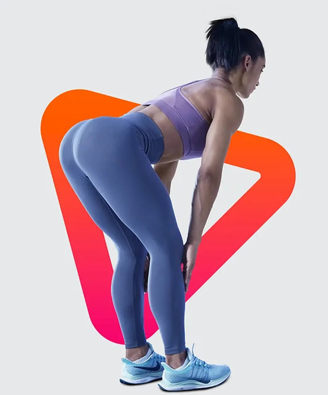 Person wearing a purple sports bra and blue leggings with a colorful abstract design in the background.
