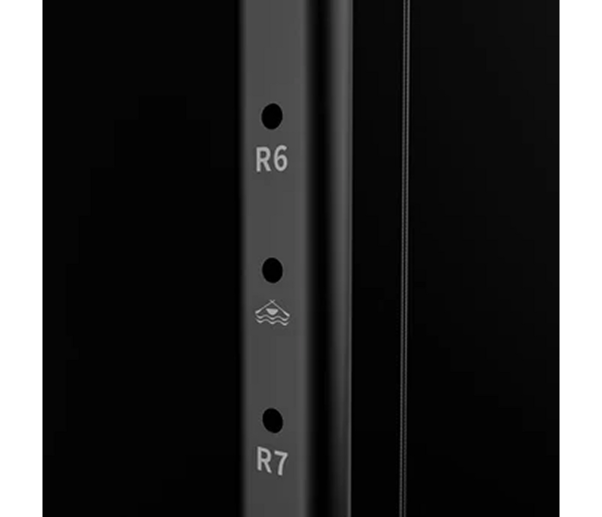 Close-up of a black cylindrical object with 'R6' and 'R7' markings on a white background