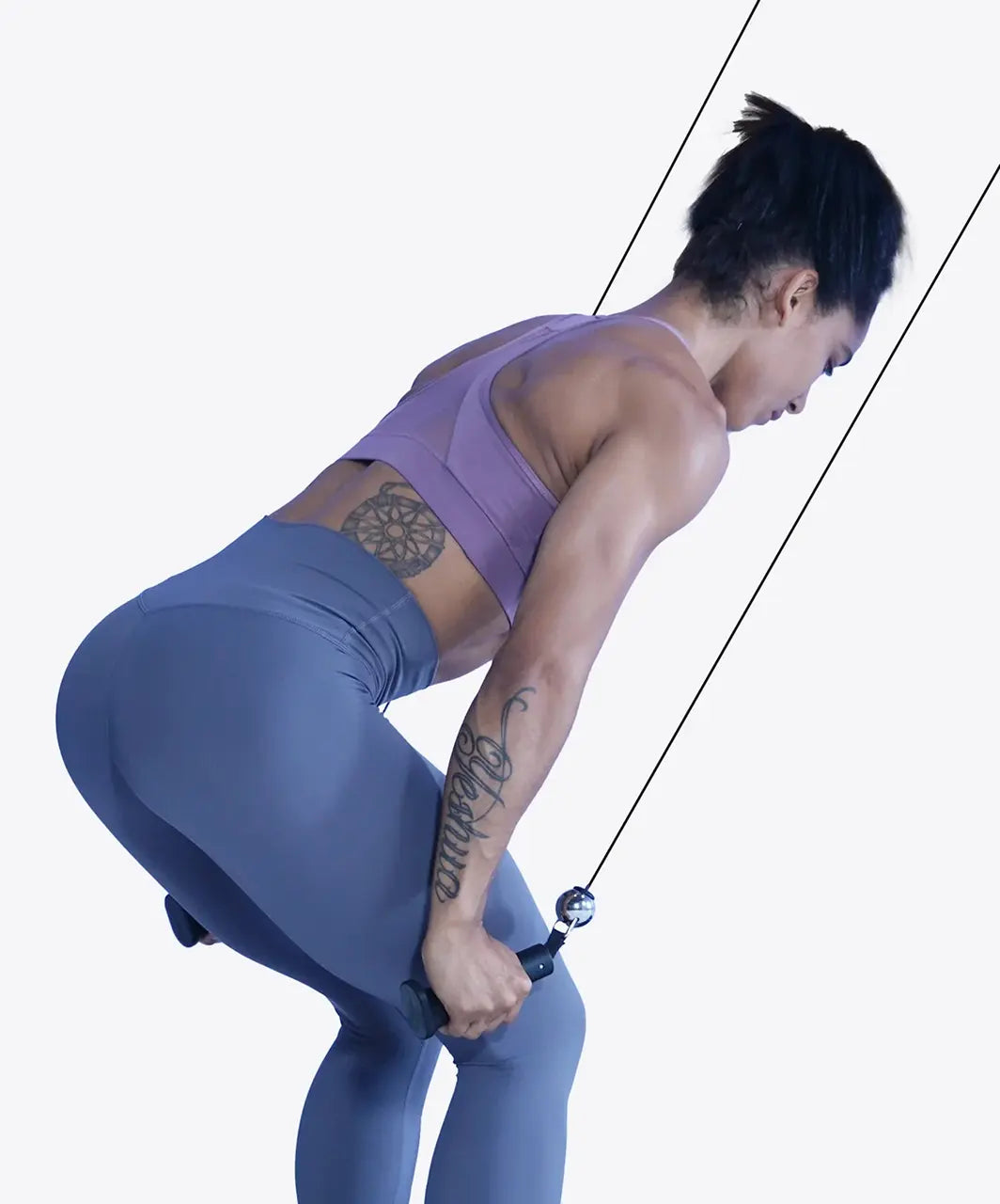 Woman exercising using a cable machine on a white background