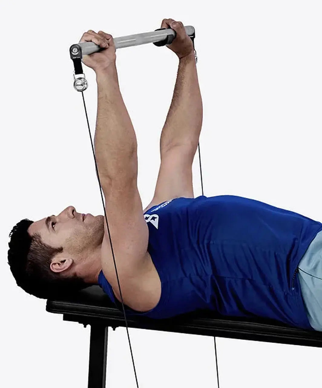 Man performing a chest exercise using a cable machine on a white background