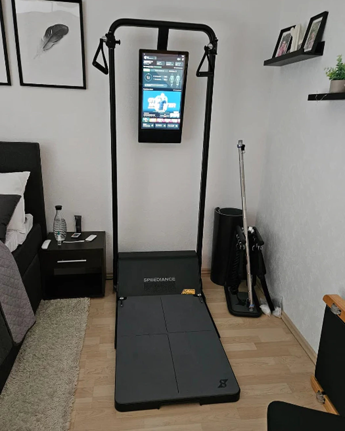 Home gym setup with a treadmill and exercise equipment in a bedroom.