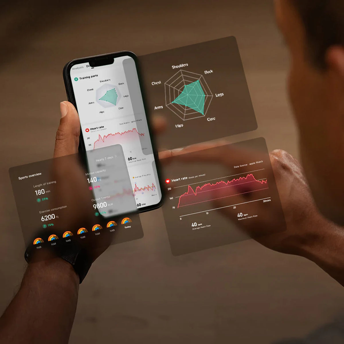 Person holding a smartphone with fitness app on a wooden surface