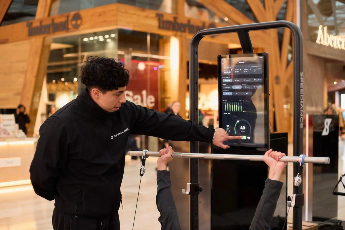 Person using a fitness machine with a digital display in a store setting