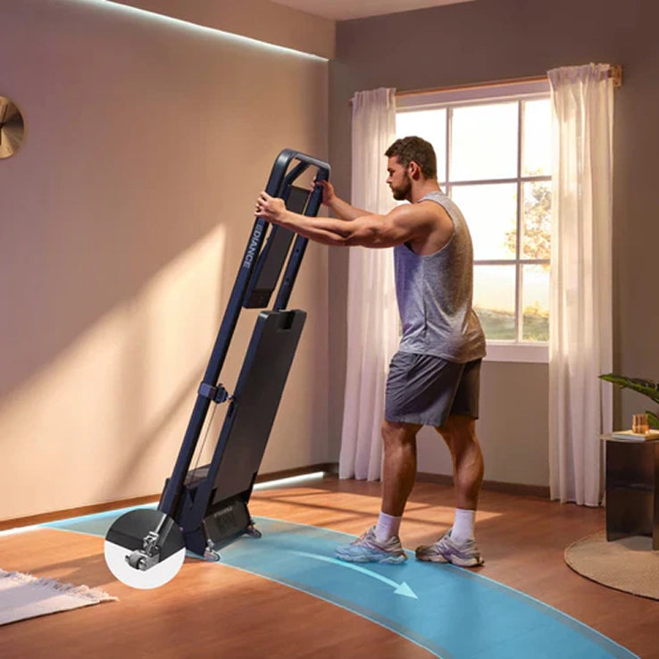 Man using a treadmill in a home setting with a large window in the background
