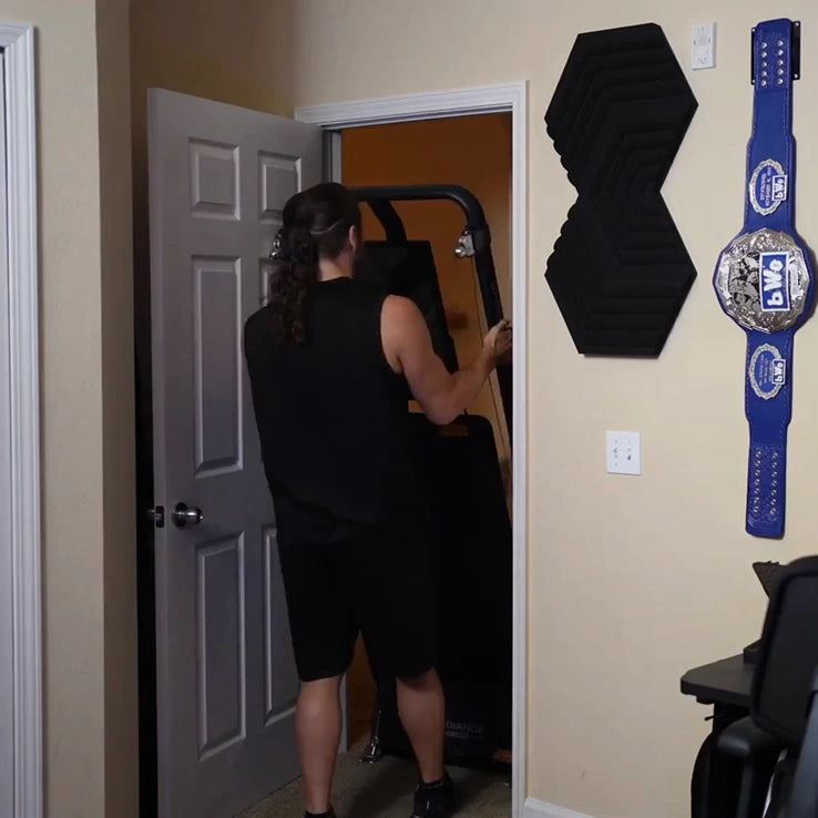 Person entering a room with a championship belt on the wall