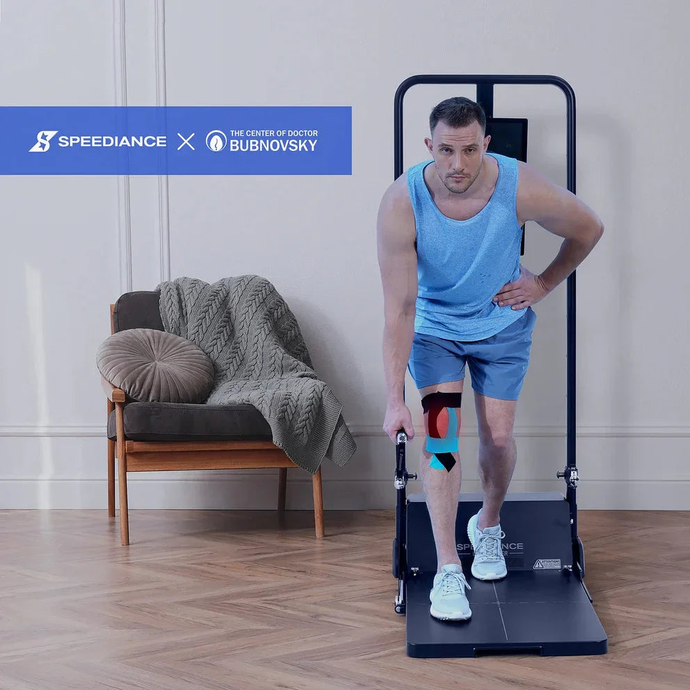 Man using a Speediance exercise machine in a home setting with a chair and blanket in the background.