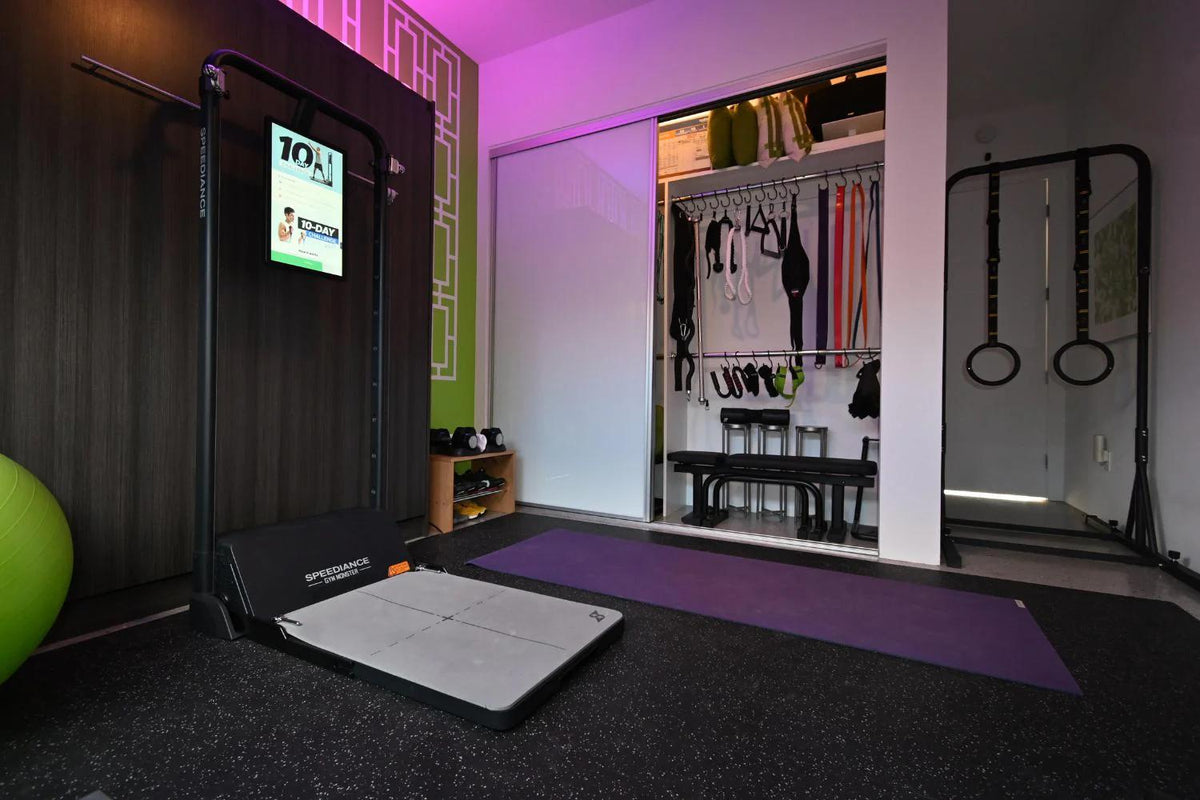 Home gym setup with treadmill, yoga mat, and fitness equipment.