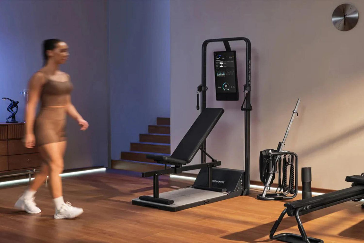 Woman walking past gym equipment in a modern interior setting