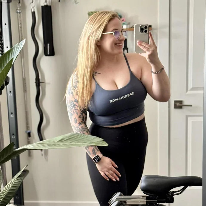 Micaela beside her Speediance home gym